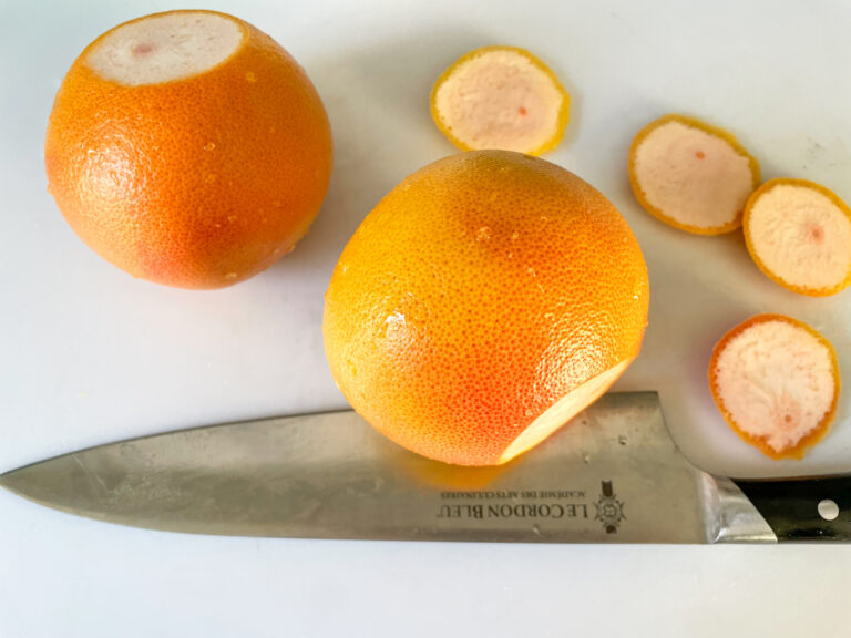Grapefruit on cutting board with knife
