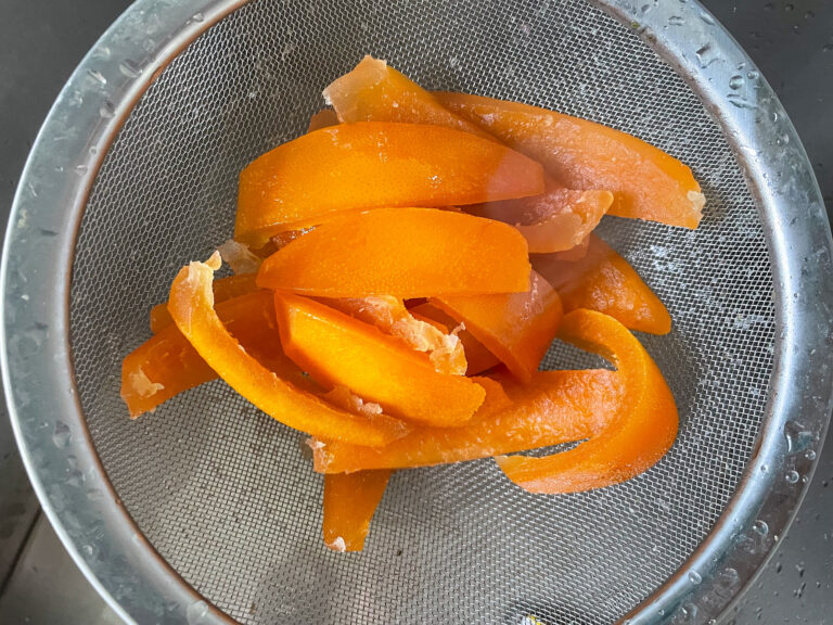Grapefruit peels in metal colander