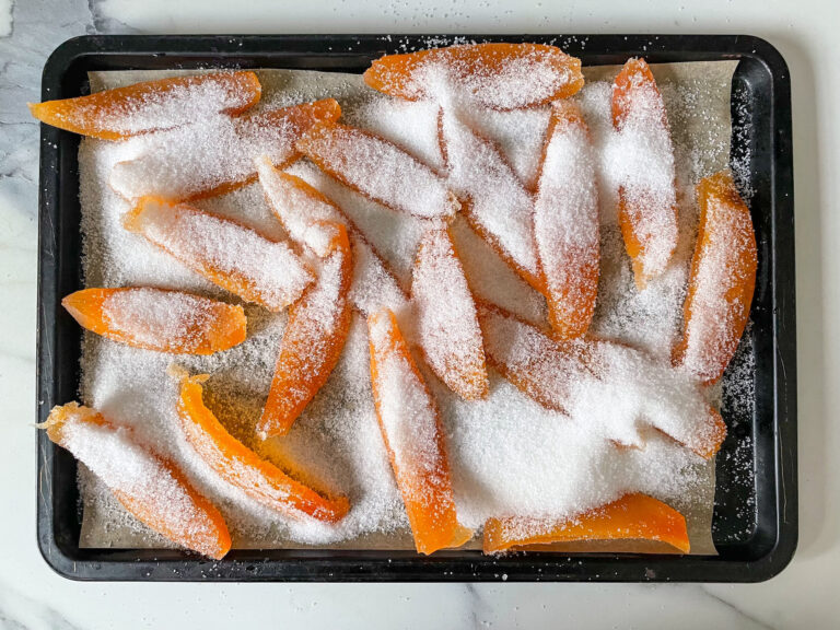 Grapefruit rind slices on tray, coated in sugar