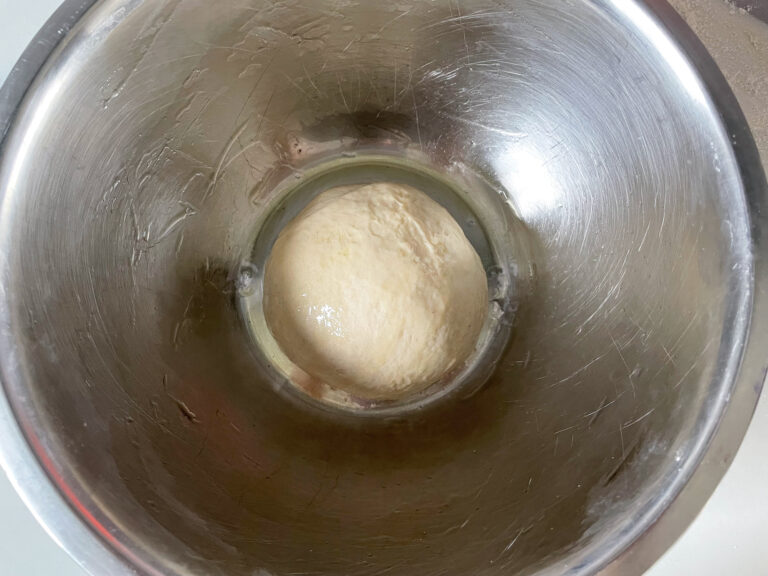 Ball of dough in metal bowl