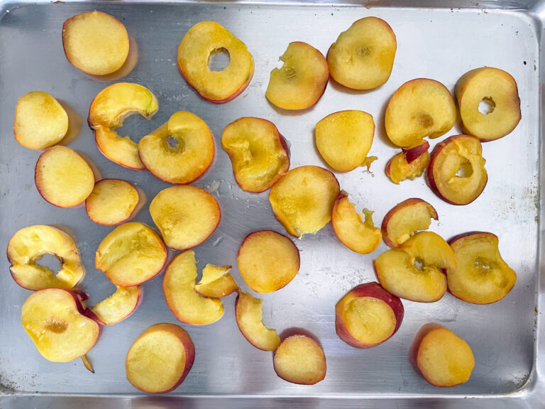 Peach slices on metal tray