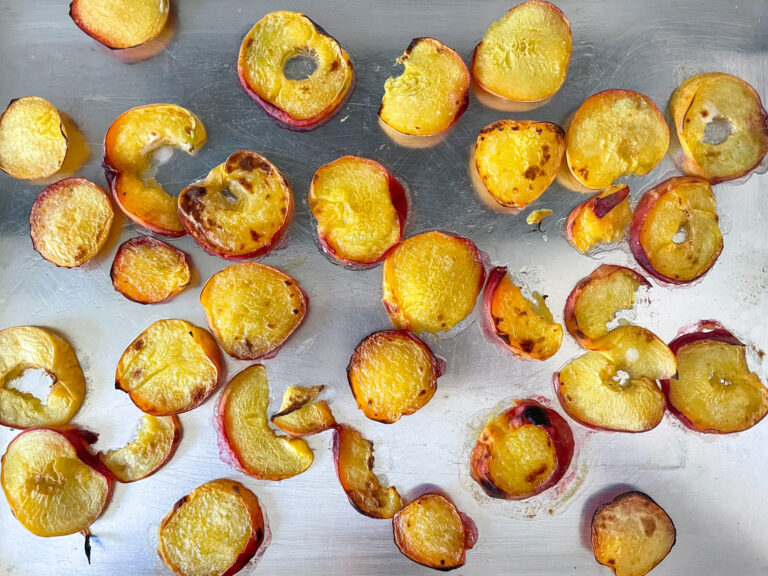 Grilled peaches on metal tray