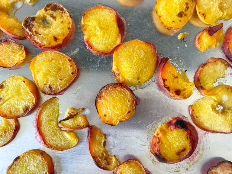 Grilled peaches on metal tray