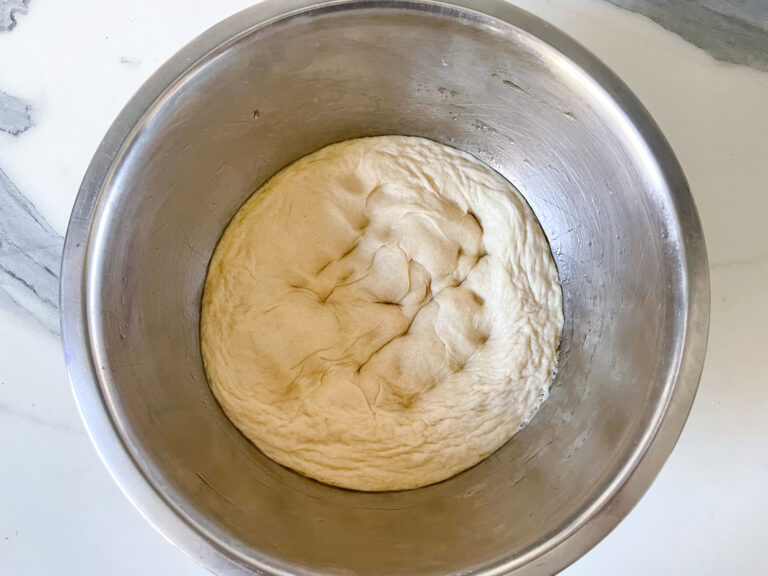 Pizza dough in metal bowl