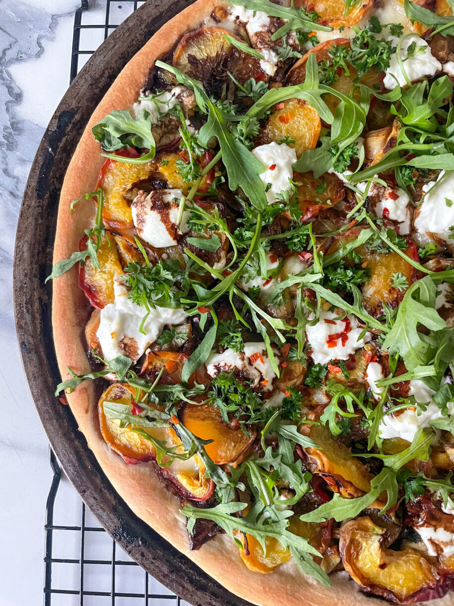 Peach and goat cheese pizza on wire rack
