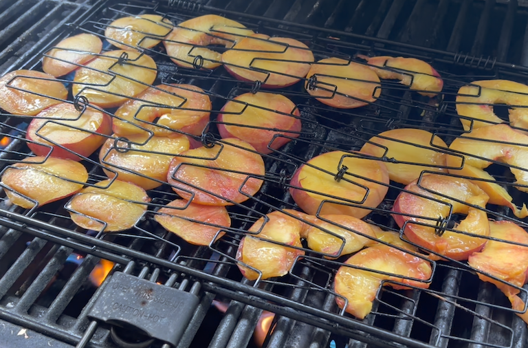 peaches grilling on an outdoor grill