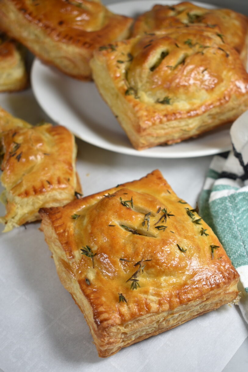 Hand pies with blue cheese and leeks, on a white plate