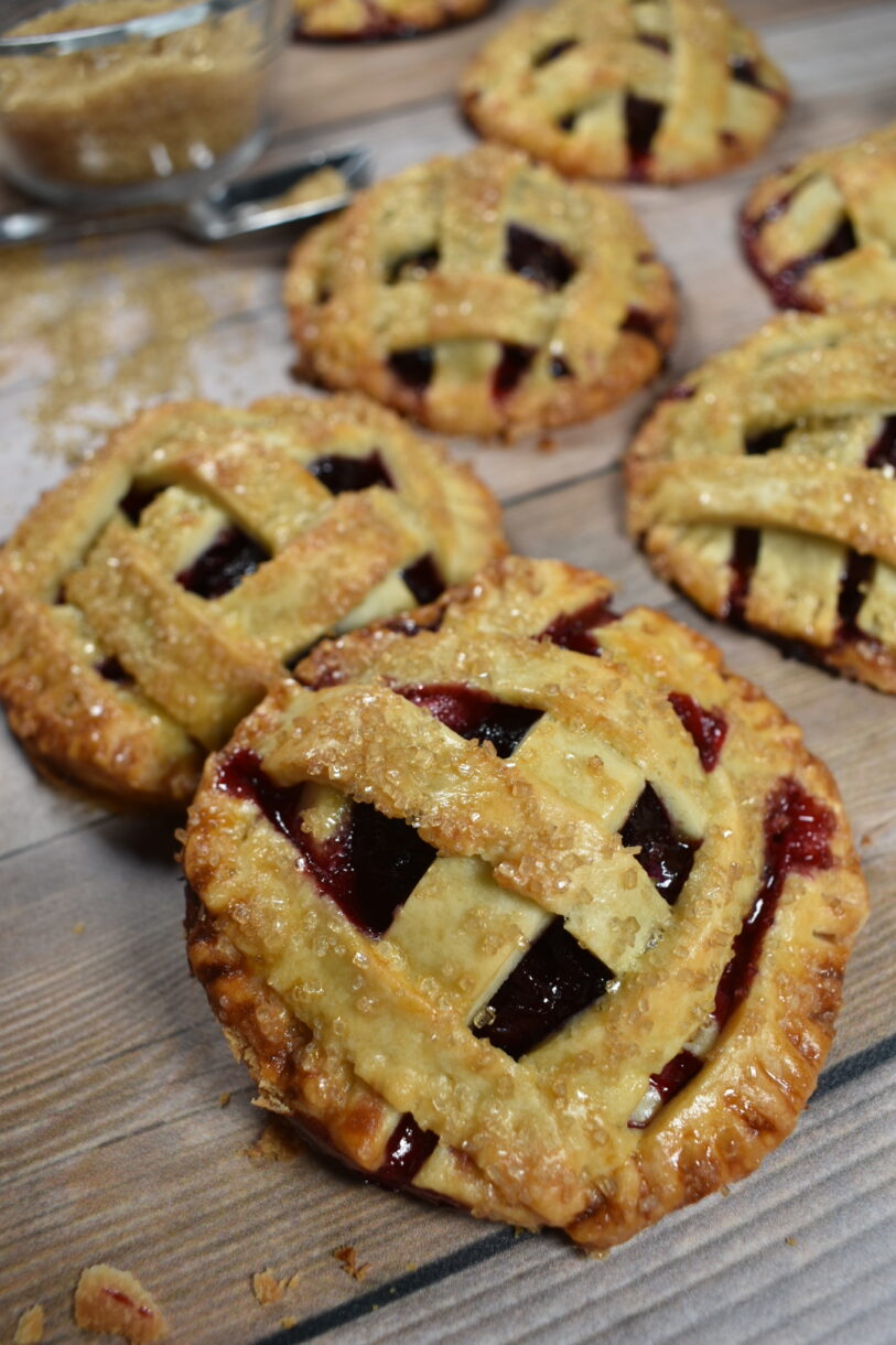 Cherry hand pies on a wooden surface