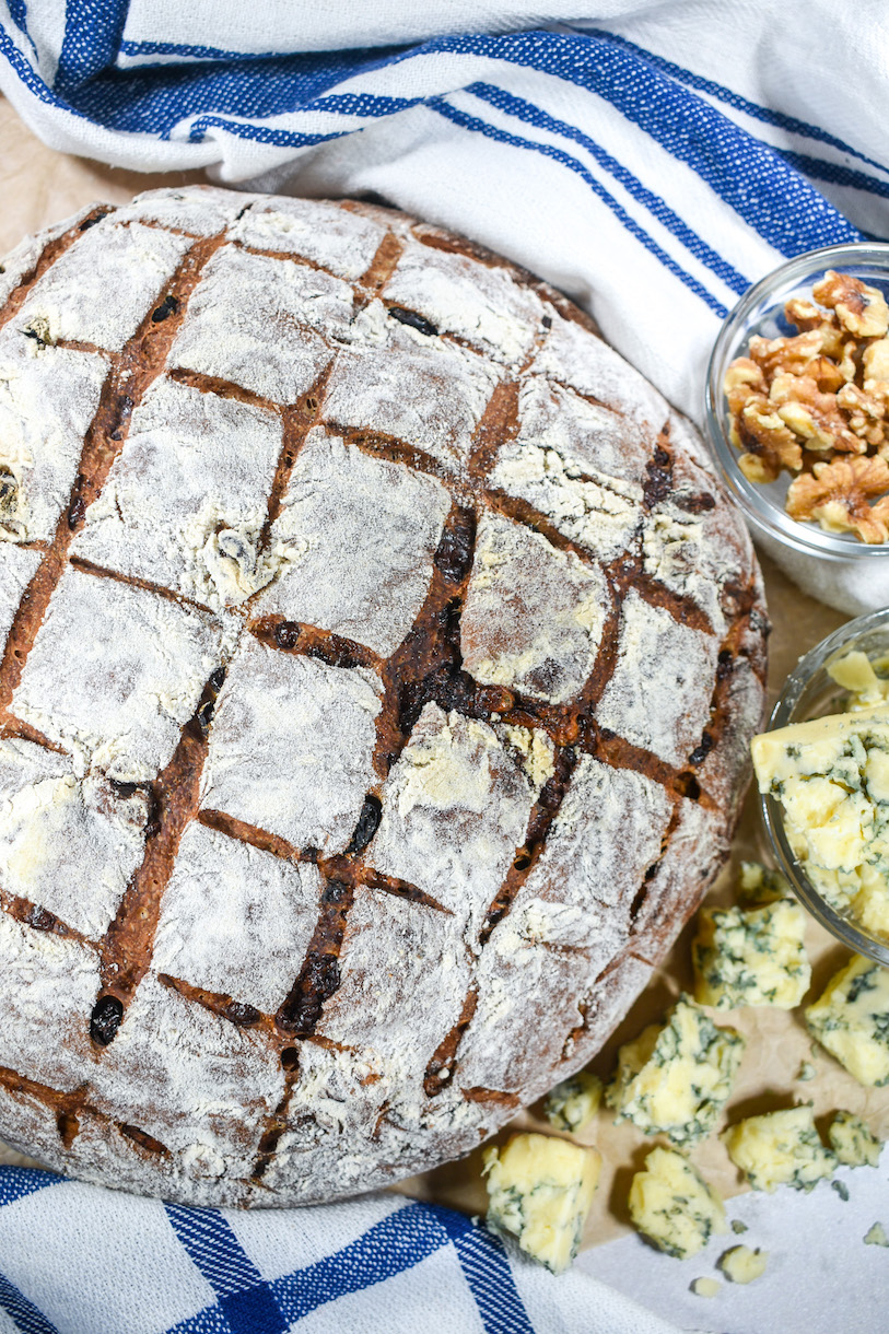 Bleu cheese bread arranged on a sheet of parchment with cheese, walnuts, and tea towels