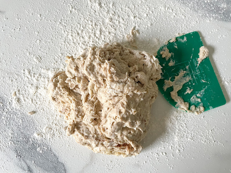 Dough on countertop with scraper