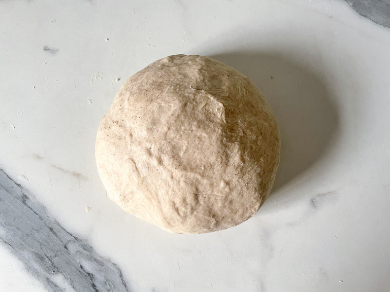Ball of dough on marble countertop