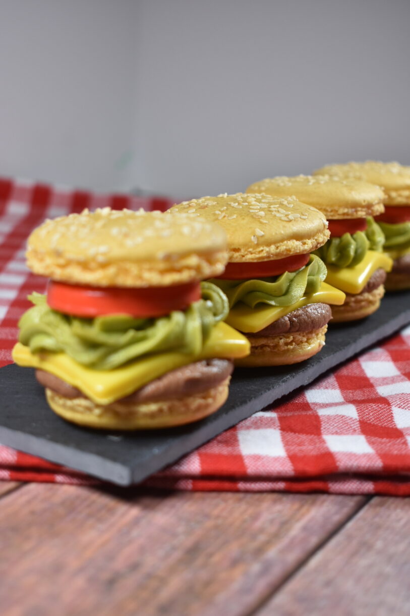 Cheeseburger macarons on a red and white checkered towel