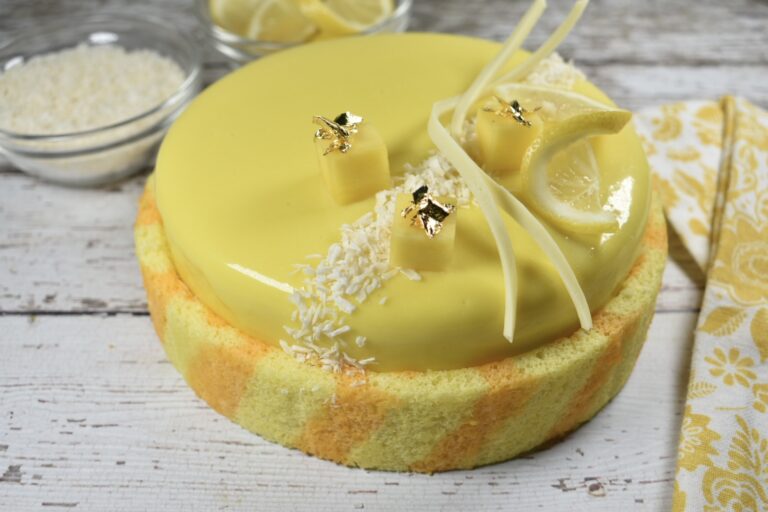 Horizontal shot of a yellow lemon and white chocolate entremet cake