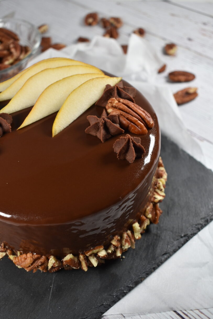 Autumn pear entremet cake with shiny mirror glacage, pears, and pecans