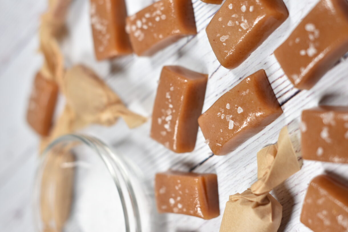 caramels arranged on a white wooden surface