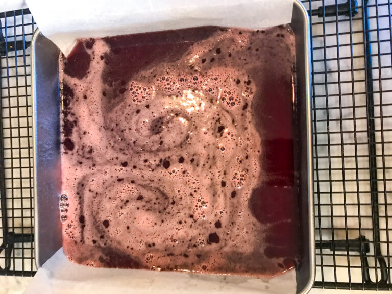 Cranberry candy in square pan on wire rack