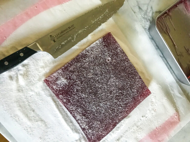 A sugared surface, candy slab, and chef's knife