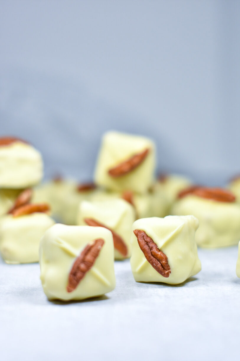 Two blondie bites decorated with white chocolate and pecans