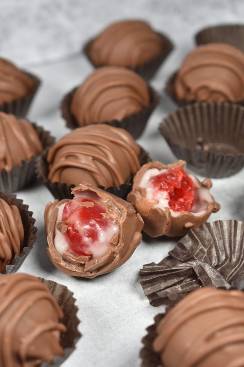 Homemade cherry cordials on a white background