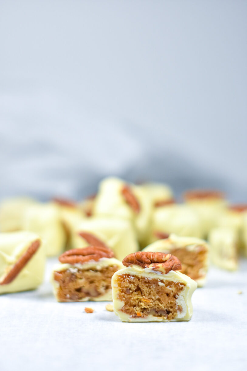 White Chocolate Blondie Bites cut in half and arranged on a white background
