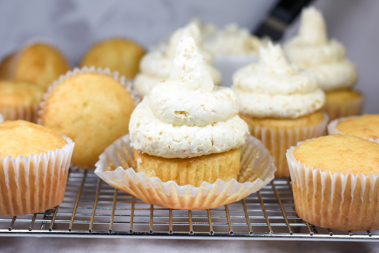 a vanilla cupcake with swirls of caramel popcorn frosting