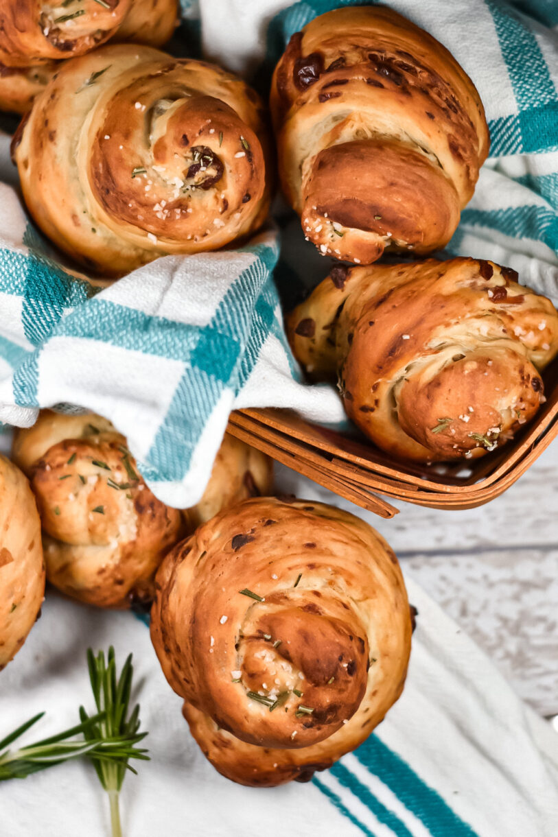 Bleu cheese, date, and rosemary bread rolls in a bread basket