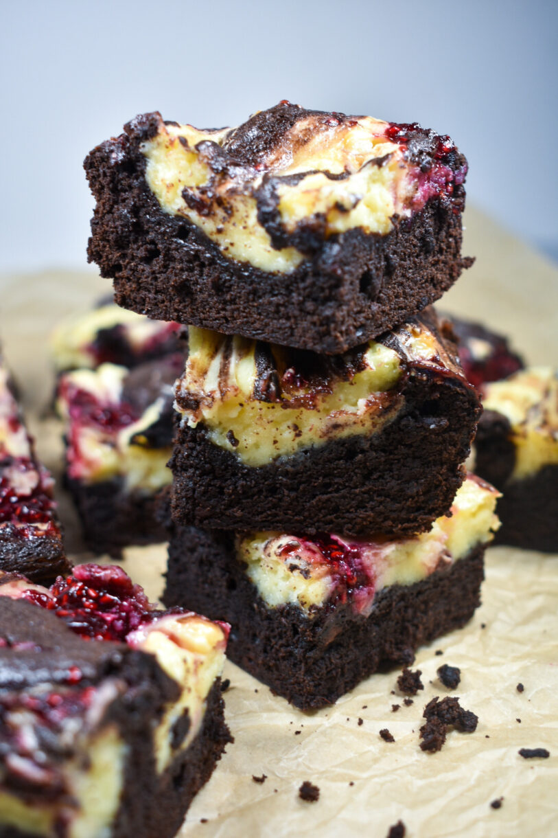 Stack of brownies on a sheet of brown parchment