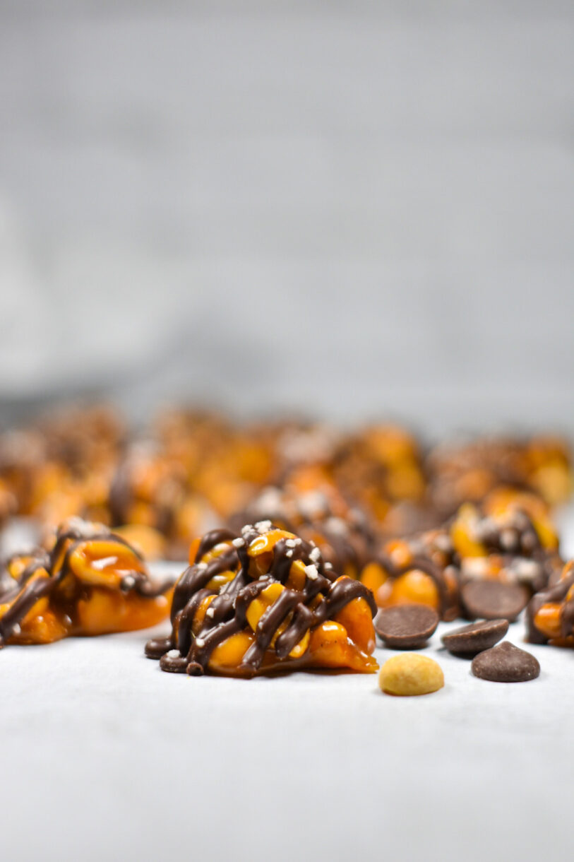 Chocolate sea salt peanut cluster on a white background