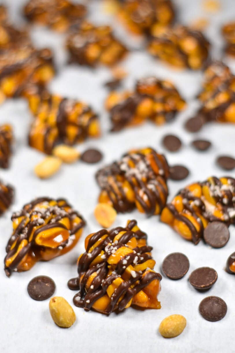 Peanut clusters and chocolate chips on a white background