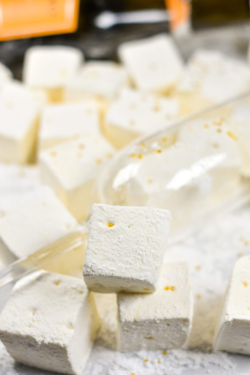 Sparkling wine marshmallows and an empty champagne glass on a white surface