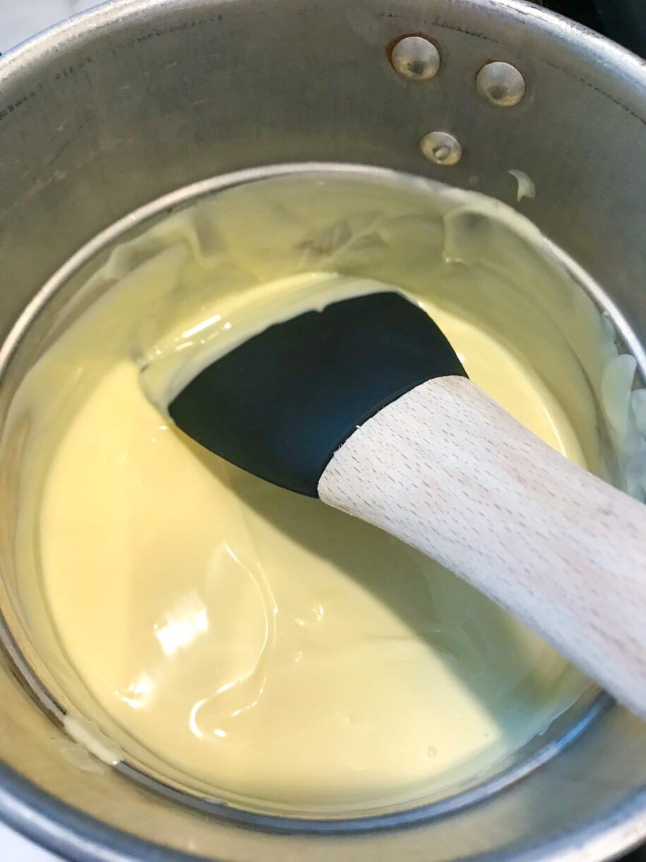 White chocolate in a double boiler with spatula