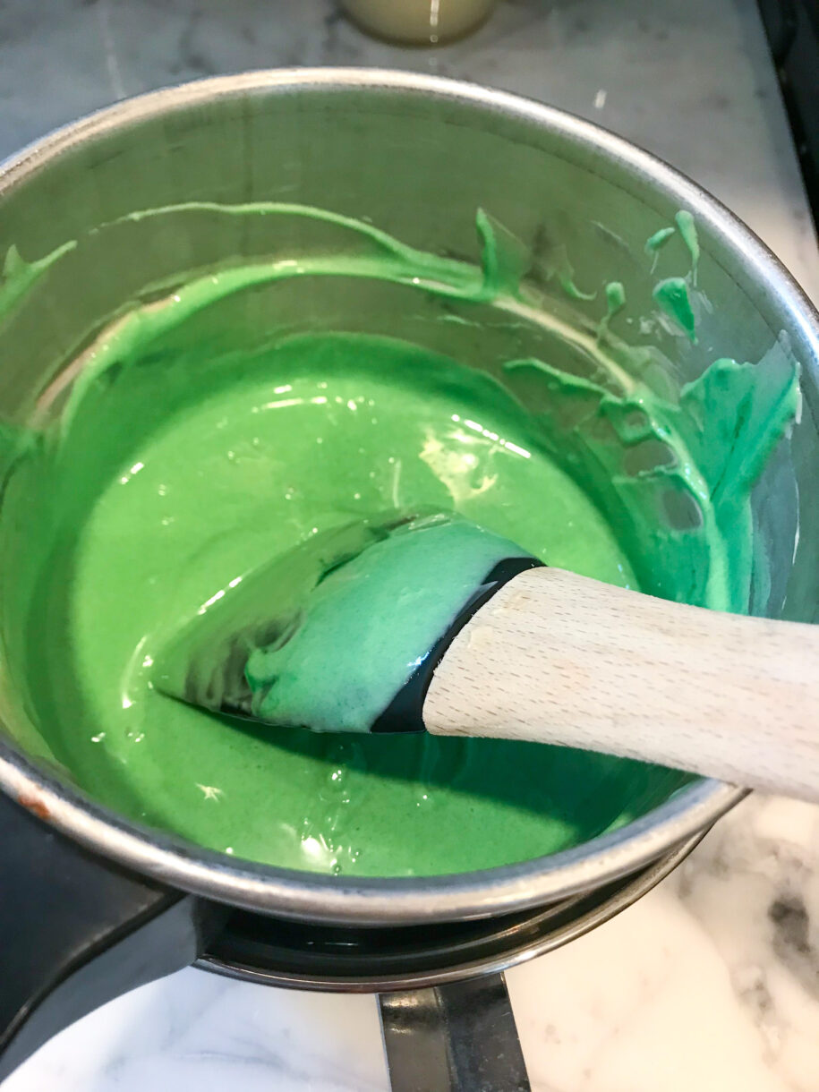 Green chocolate in a double boiler with spatula