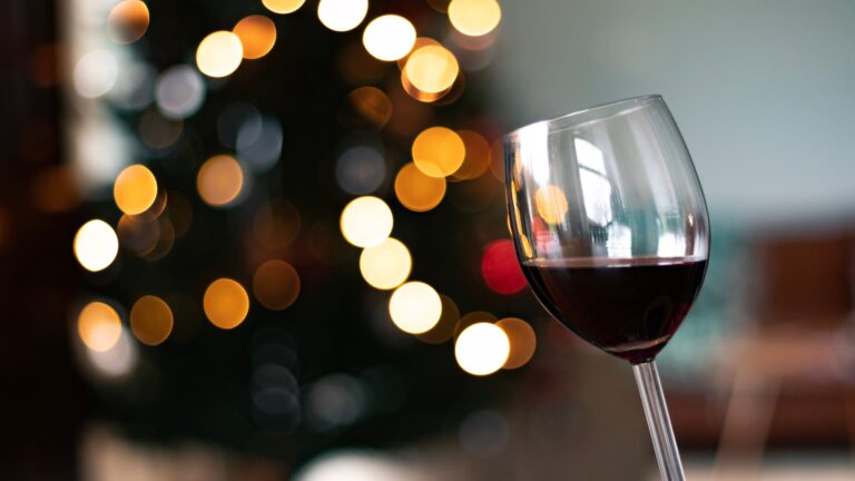 Glass of red wine with twinkling lights
