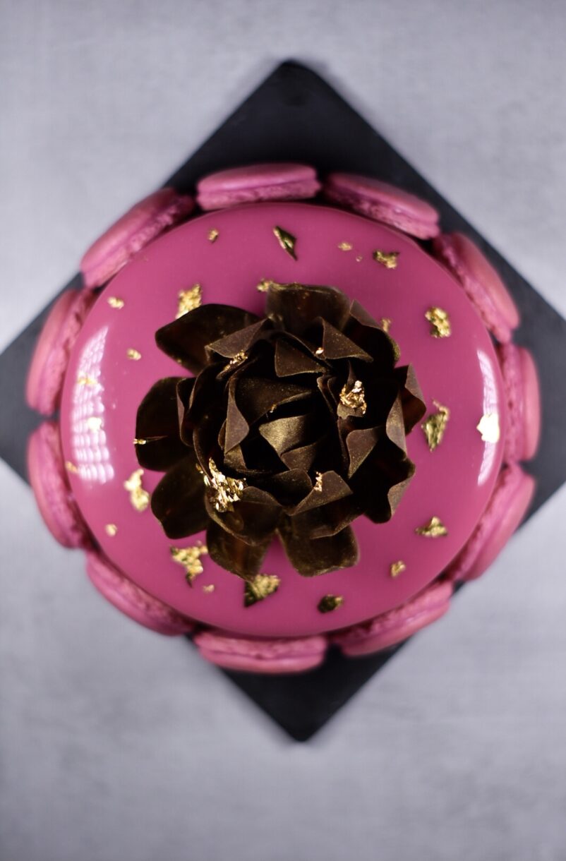 Looking down at a pink passionfruit, coffee, and chocolate entremet