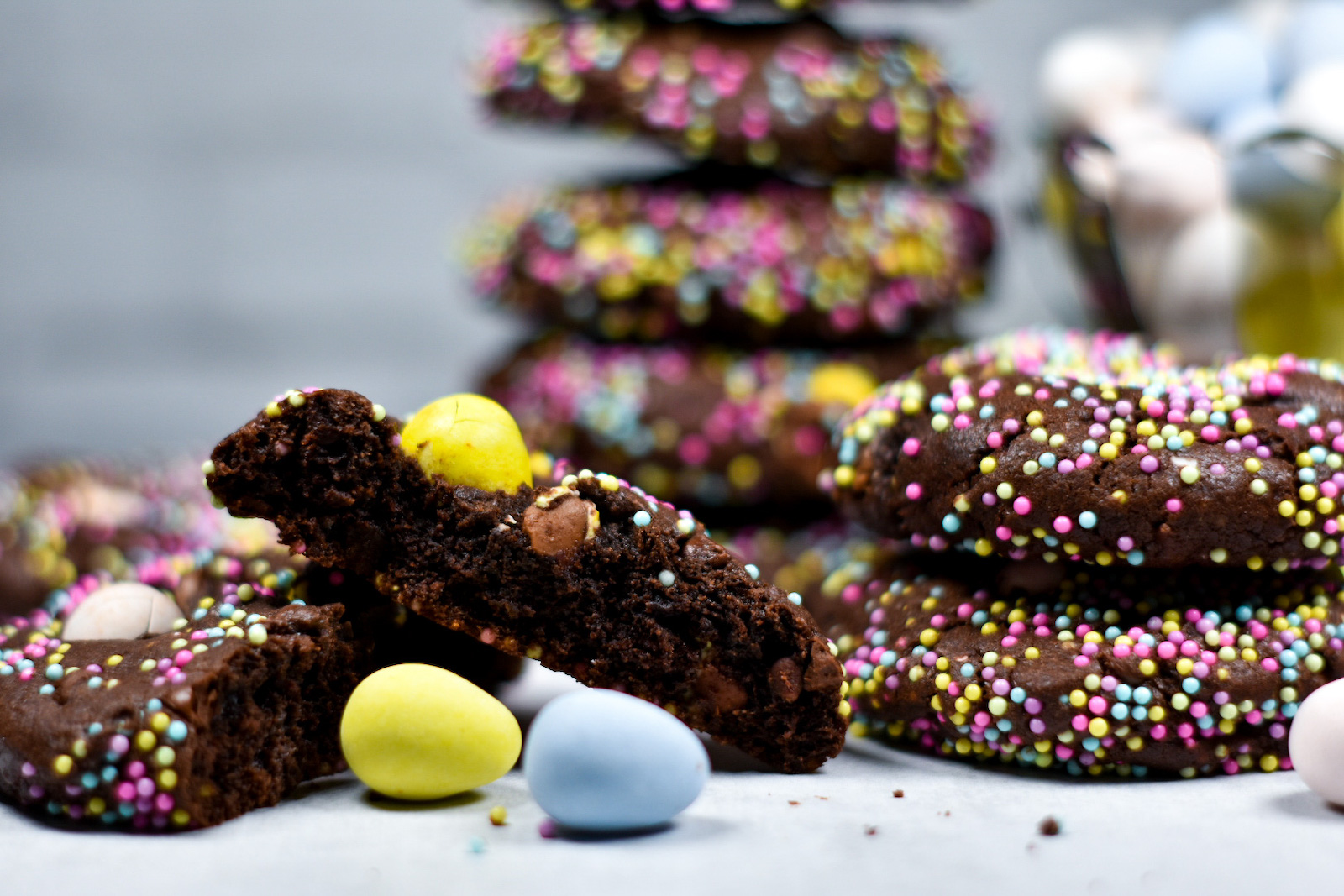 chocolate cookies and mini eggs on a white surface