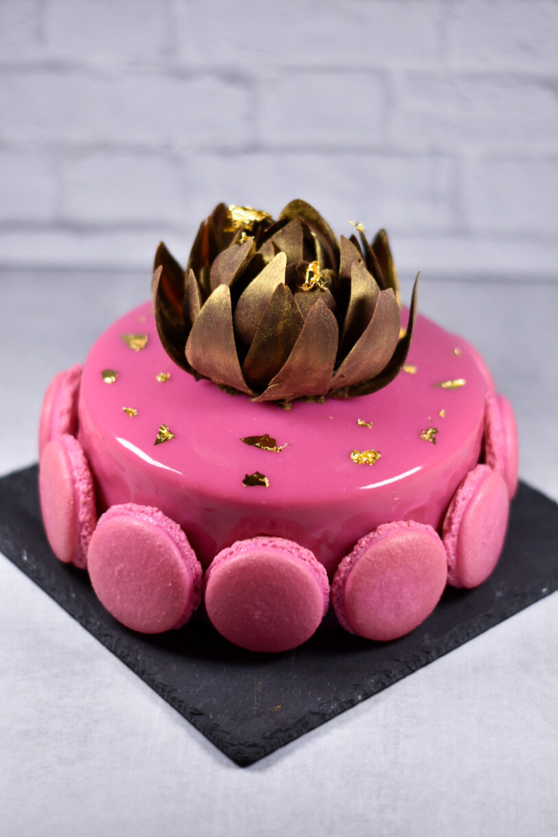 Passionfruit, coffee, and chocolate entremet on a black slate plate