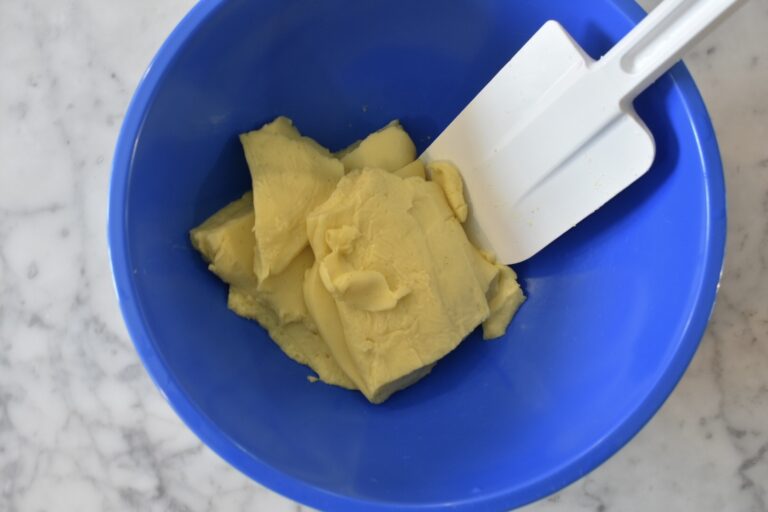 Pastry cream and spatula in blue plastic bowl