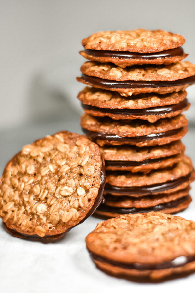 A stack of chai spiced oatmeal sandwich cookies on a white background