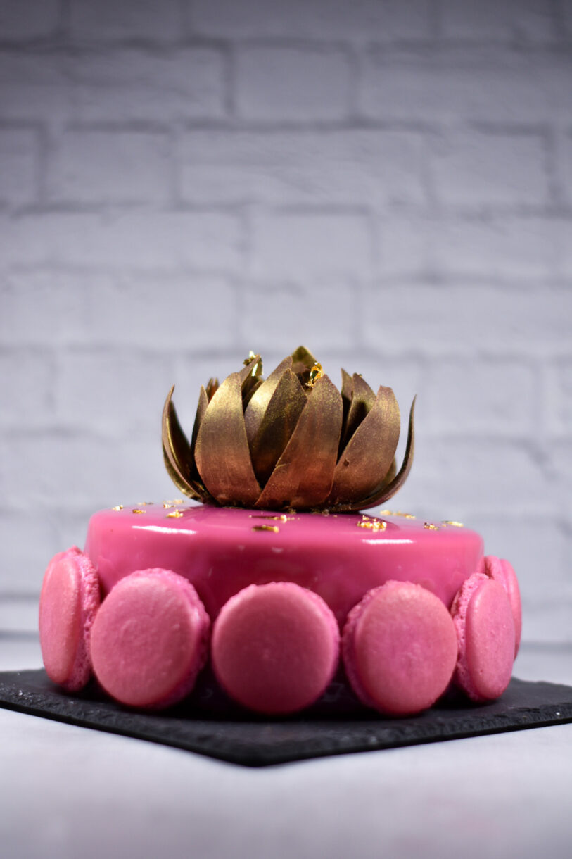 Passionfruit, coffee, and chocolate entremet with chocolate rose and macarons