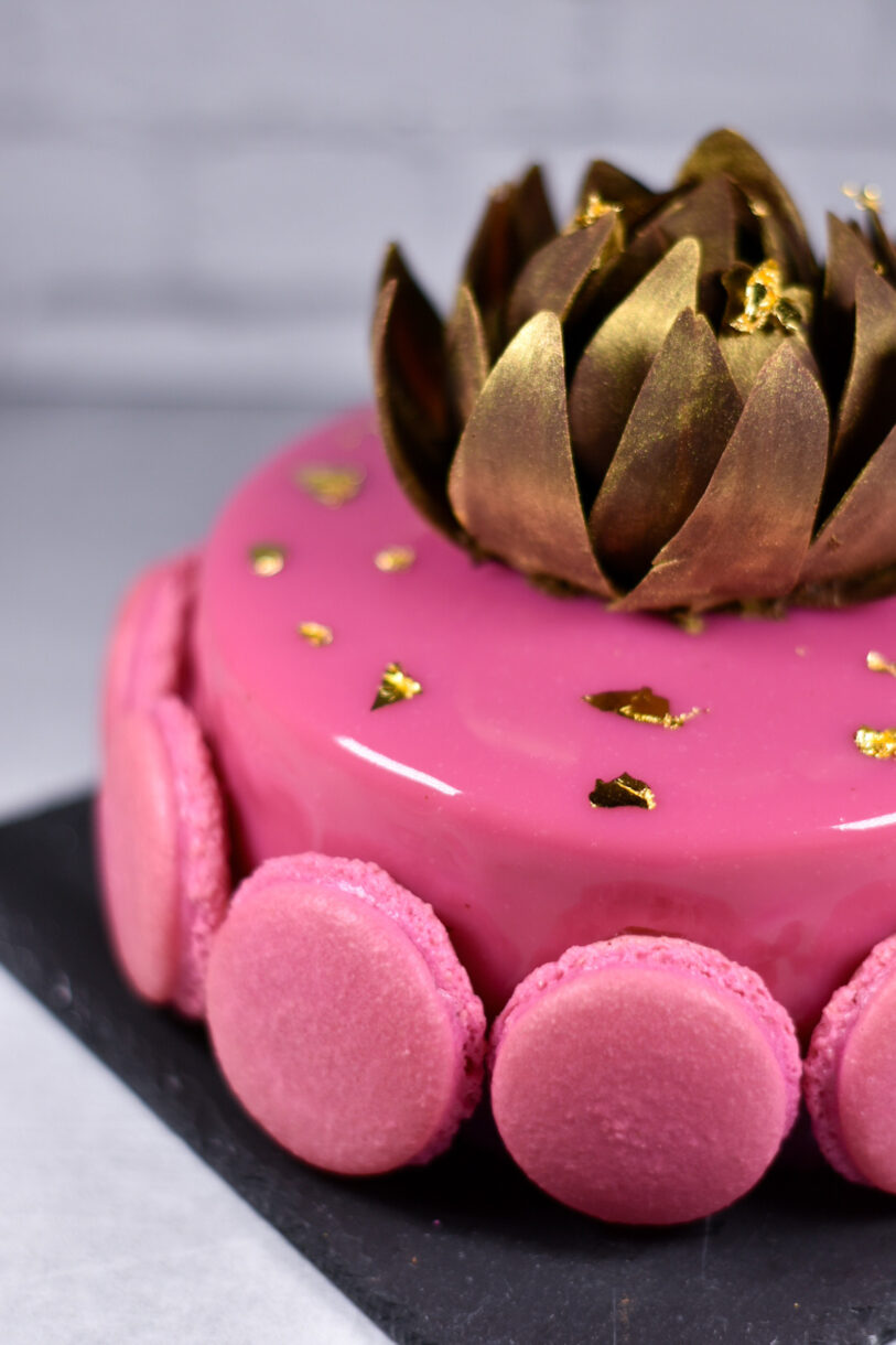 Passionfruit, coffee, and chocolate entremet with gold rose on top