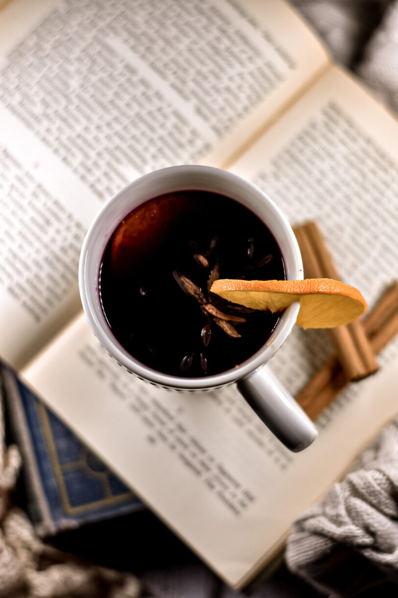 A mug of mulled wine sitting on a stack of books