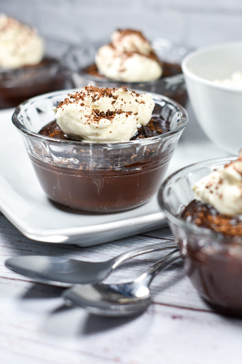 Chocolate Irish Cream Pudding and a pair of spoons on a white plate