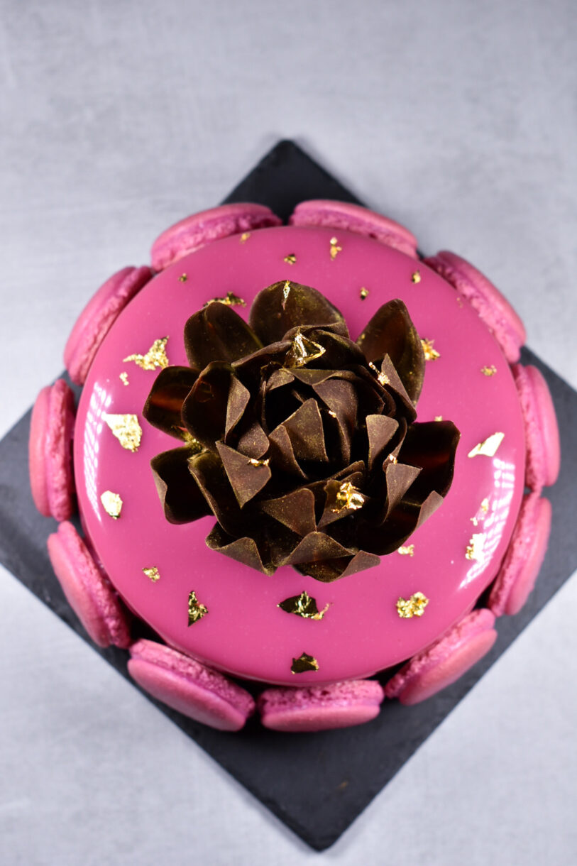 Passionfruit, coffee, and chocolate entremet on a black slate 