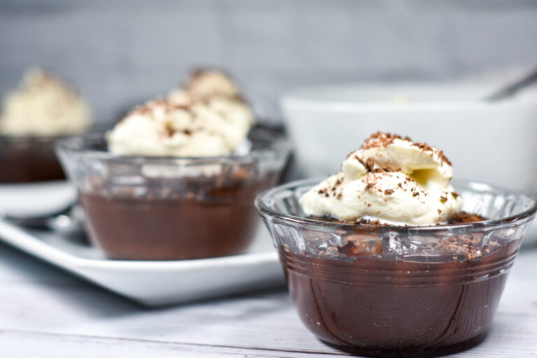 Bowls of chocolate Irish cream pudding on a white surface