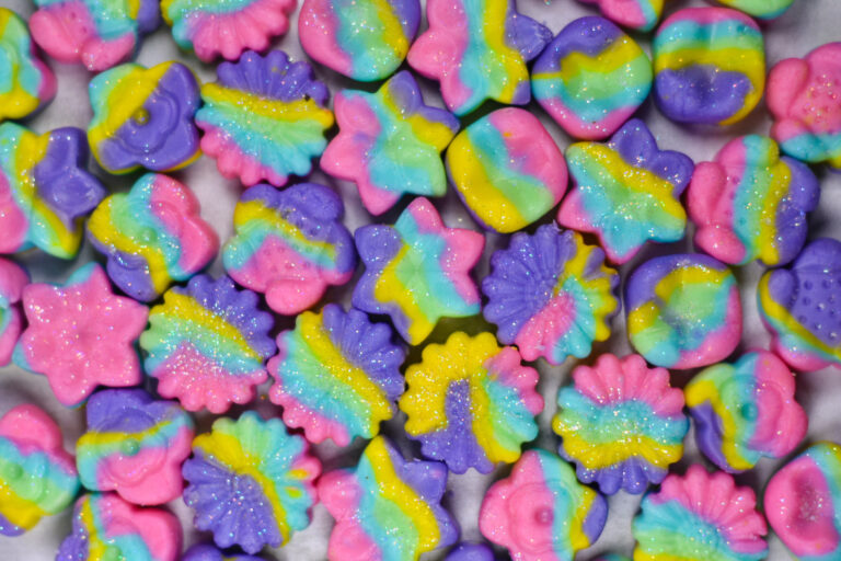 multicolored cream cheese peppermints on a white surface