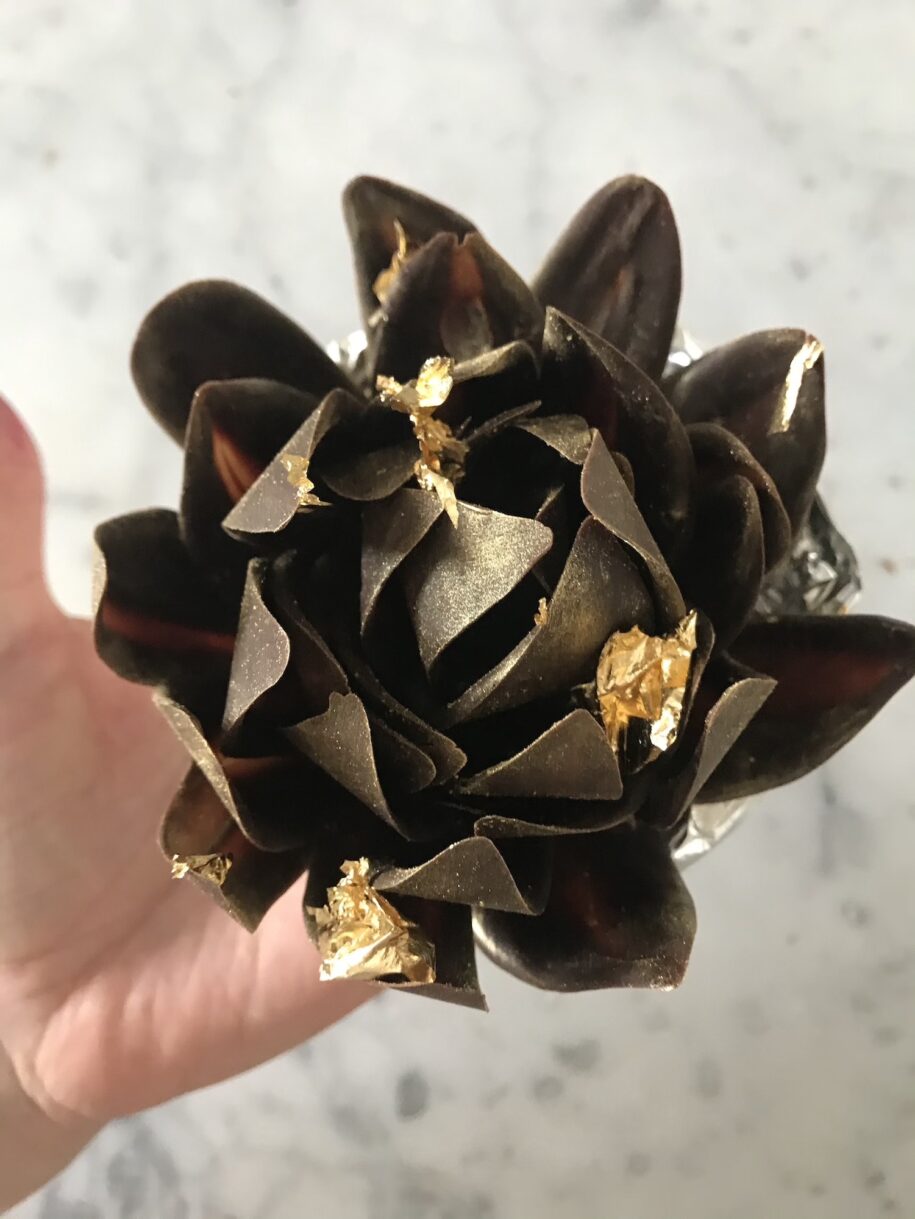 Hand holding a chocolate rose