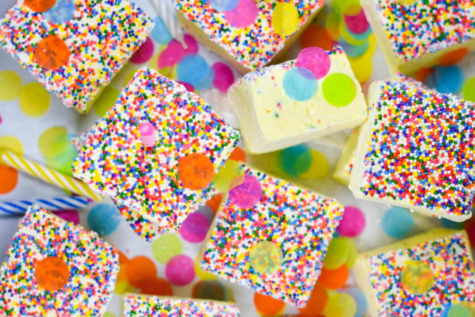marshmallows arranged on a white surface with sprinkles and confetti