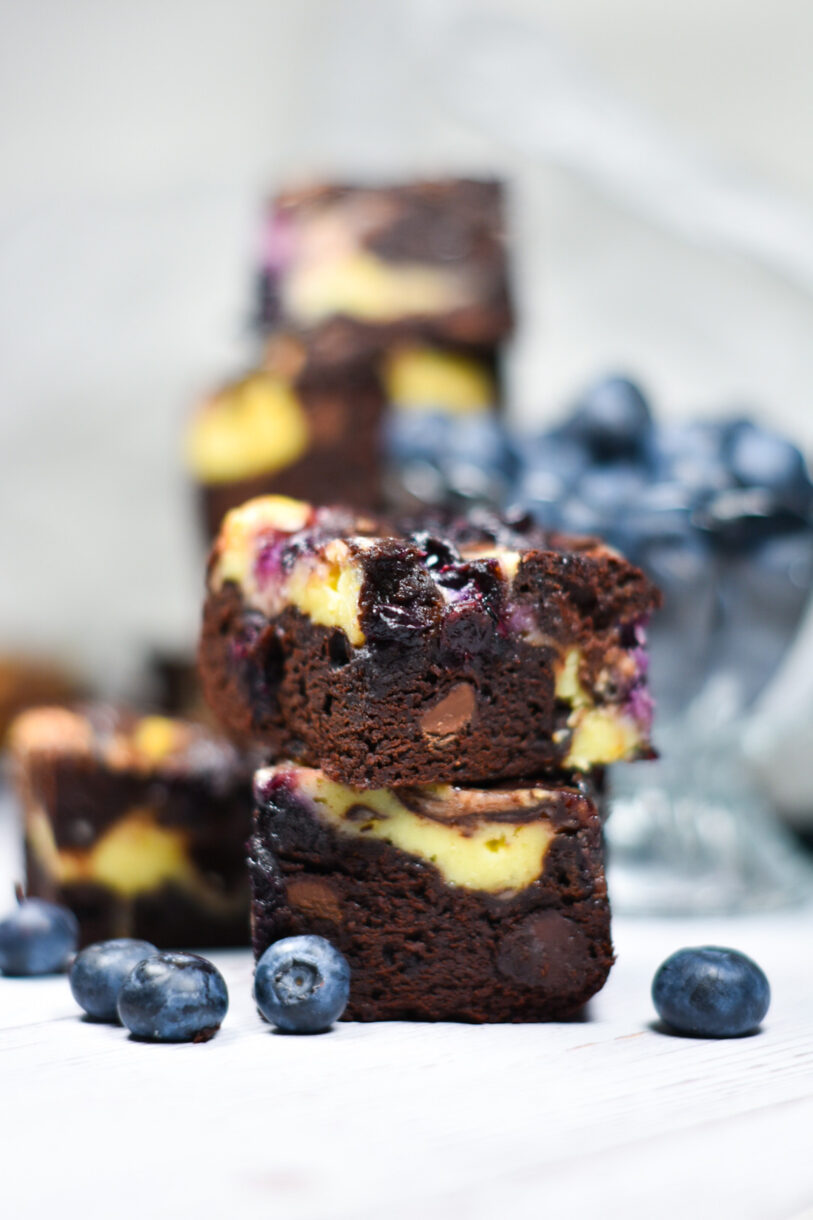 A stack of blueberry lemon cheesecake brownies