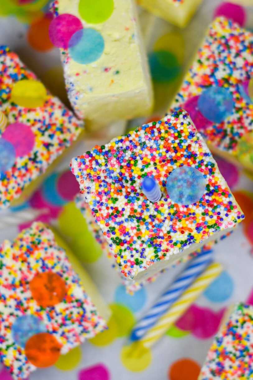 Looking down at a stack of birthday cake marshmallows, with a candle on top