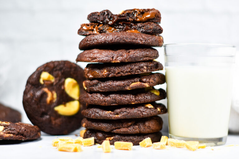 Horizontal photo of a stack of cookies and a glass of milk, on a white background